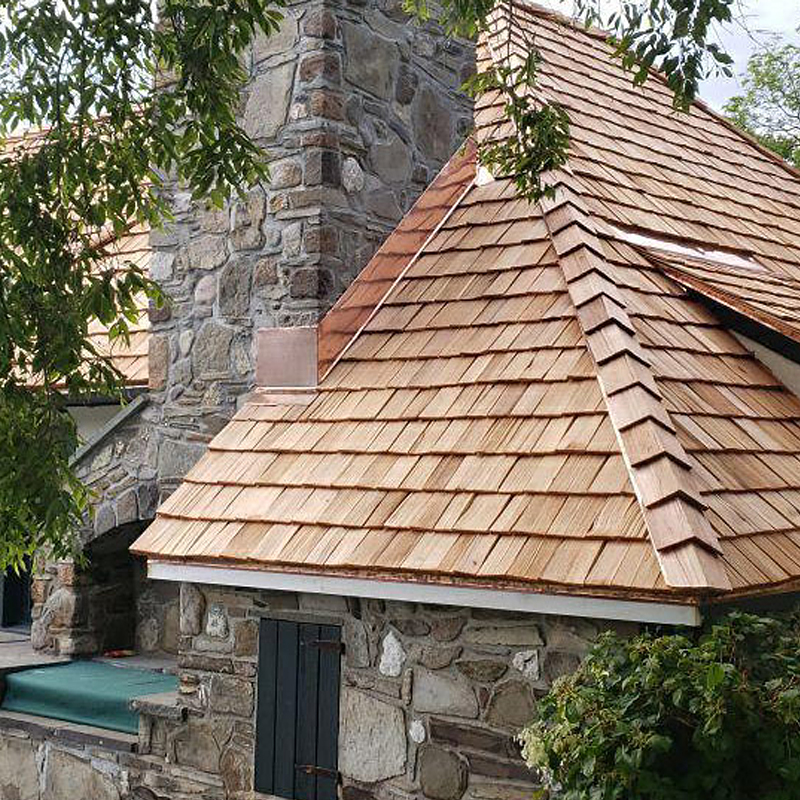 Cedar shingle roof and stone structure.